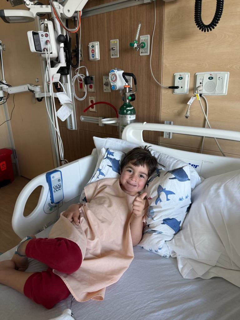 Benji giving a thumbs-up from his hospital bed