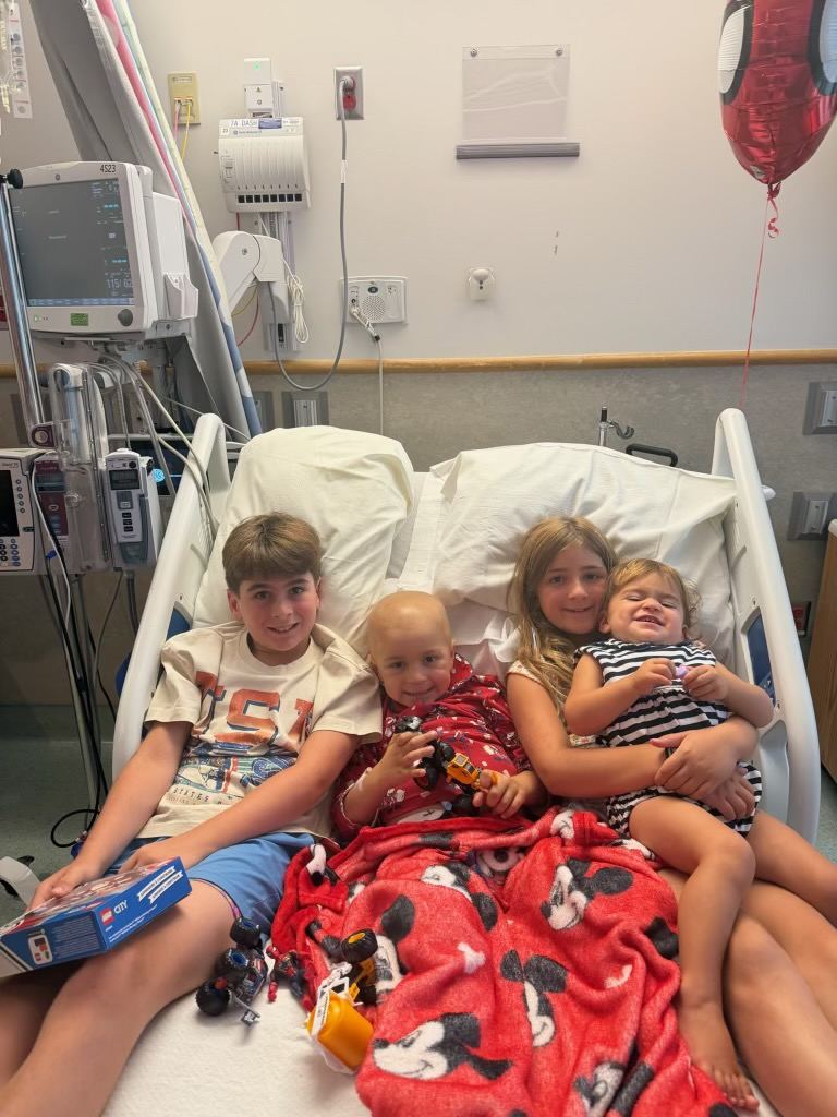 Benji in his hospital bed with his siblings Bowen, Andi and Harley