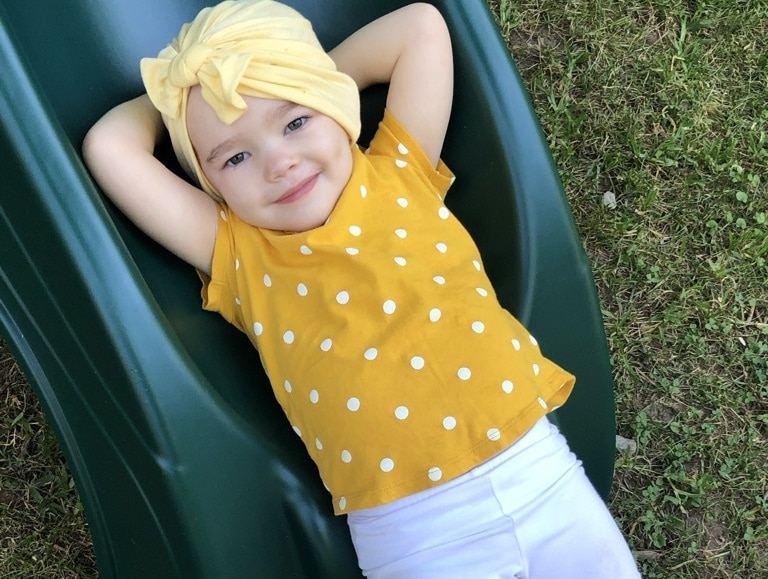 Rally Kid Millie lying down on a slide