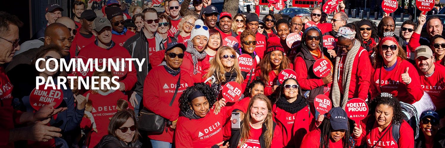 Community Partners. A large group of Delta employees in red Rally shirts at a community run.