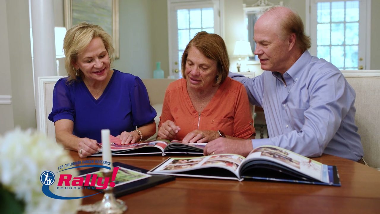 Dean Crowe and William’s family looking through a photo book